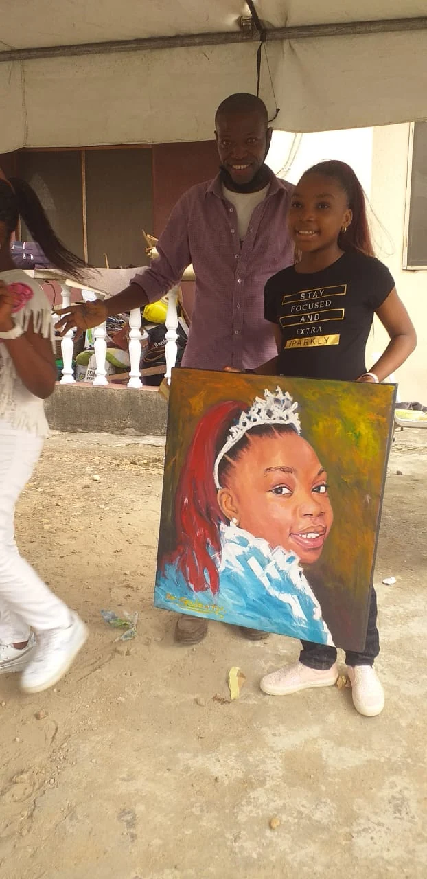 Young participant presenting a portrait painting